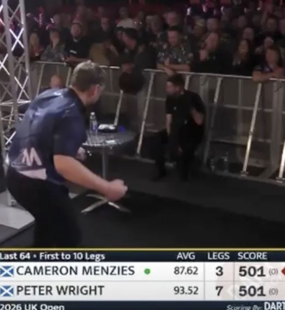 Cameron Menzies pretended to punch a table during his match against Peter Wright, leaving the crowd in stitches