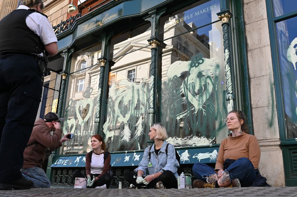 Campaigners daubed green paint onto the shop windows of William Evans shooting supplies store in London. Picture date: Saturday October 8, 2022.