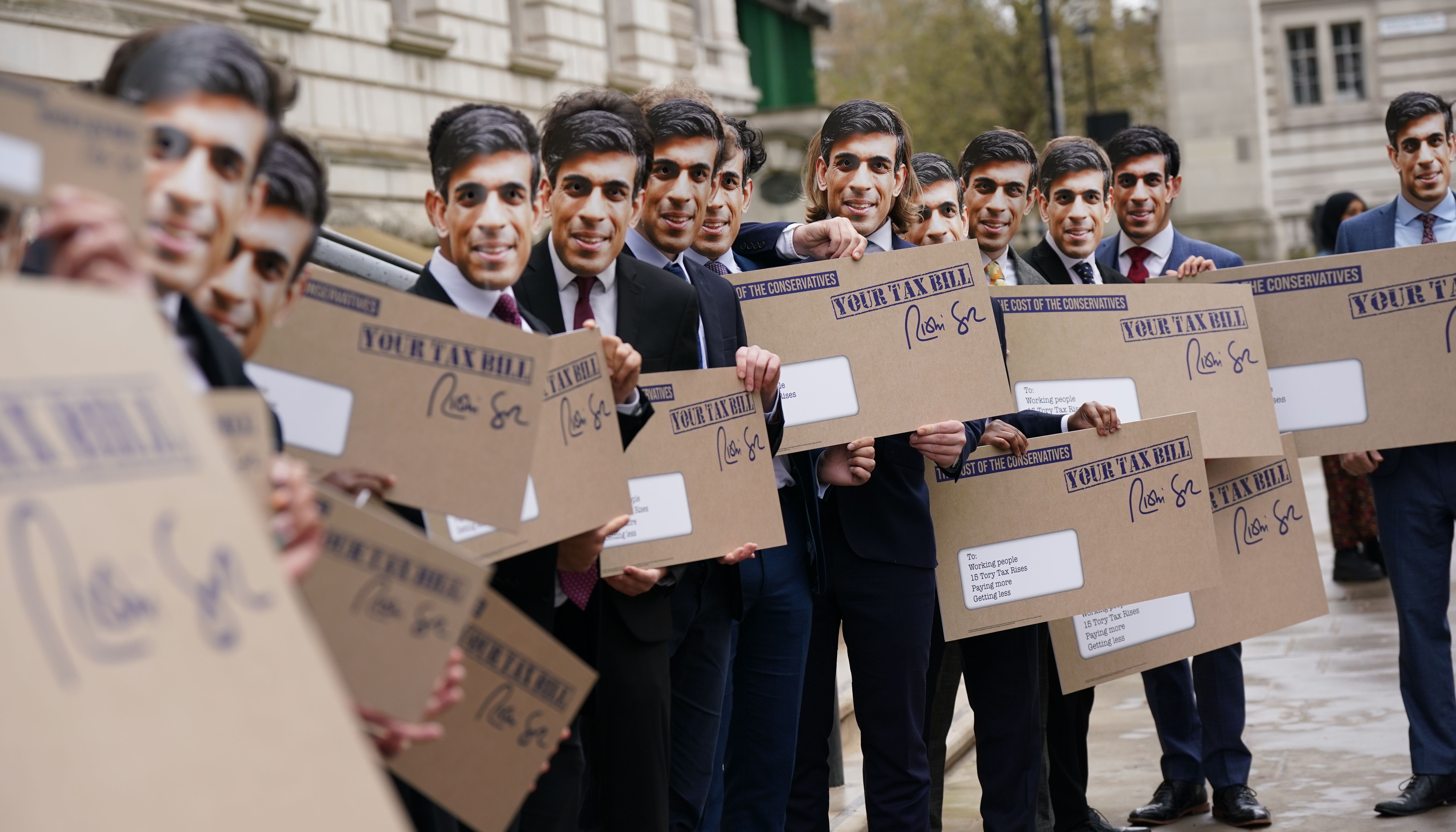 Campaigners dressed as Rishi Sunak protest outside the Treasury office, London, to coincide with the increase in National Insurance Contributions coming into effect.