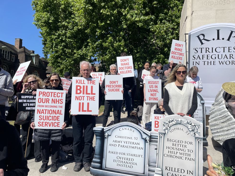 Campaigners opposing the assisted dying legislation demonstrate outside the Palace of Westminster in London,