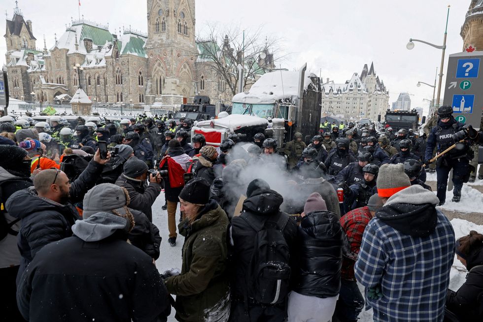 Canadian police officers face off with protestors on Parliament Hill, as they work to restore normality to the capital while trucks and demonstrators continue to occupy the downtown core for more than three weeks to protest against pandemic restrictions in Ottawa, Canada
