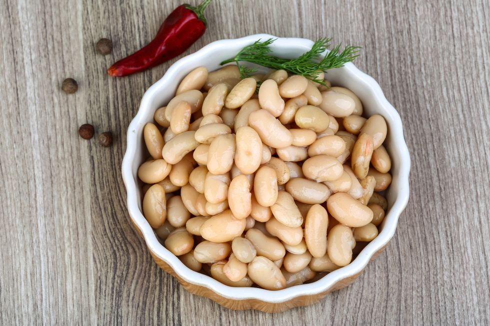 Canned white beans with green fresh dill leaf