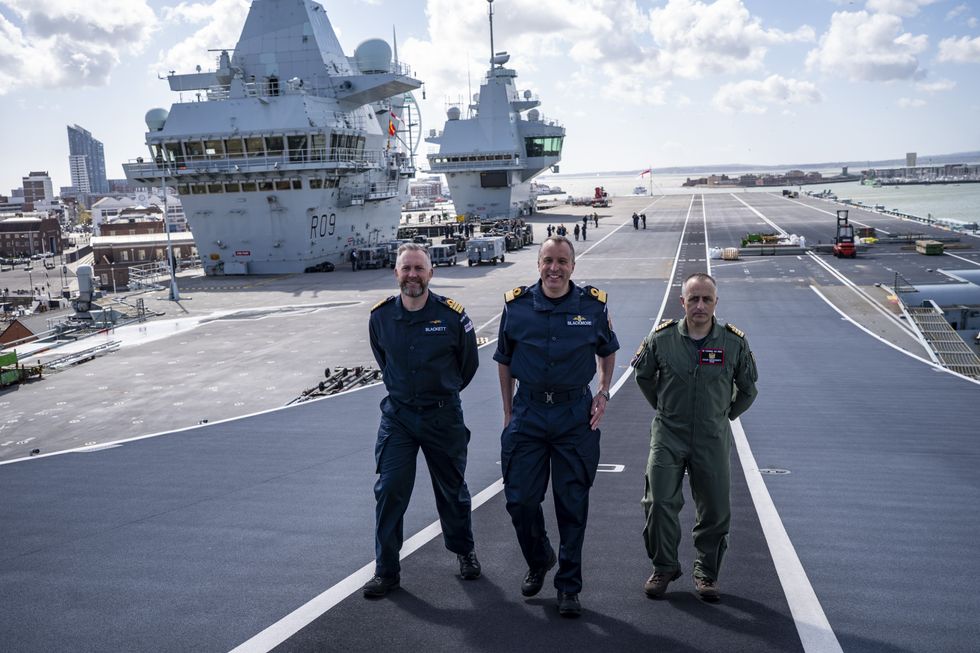 Captain Will Blackett, Commodore James Blackmore RN, Commander Carrier Strike Group and Captain Colin McGannity, Commander Air Group onboard HMS Prince of Wales docked at HM Naval Base Portsmouth