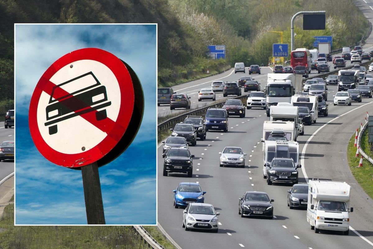 Car ban sign and a busy motorway
