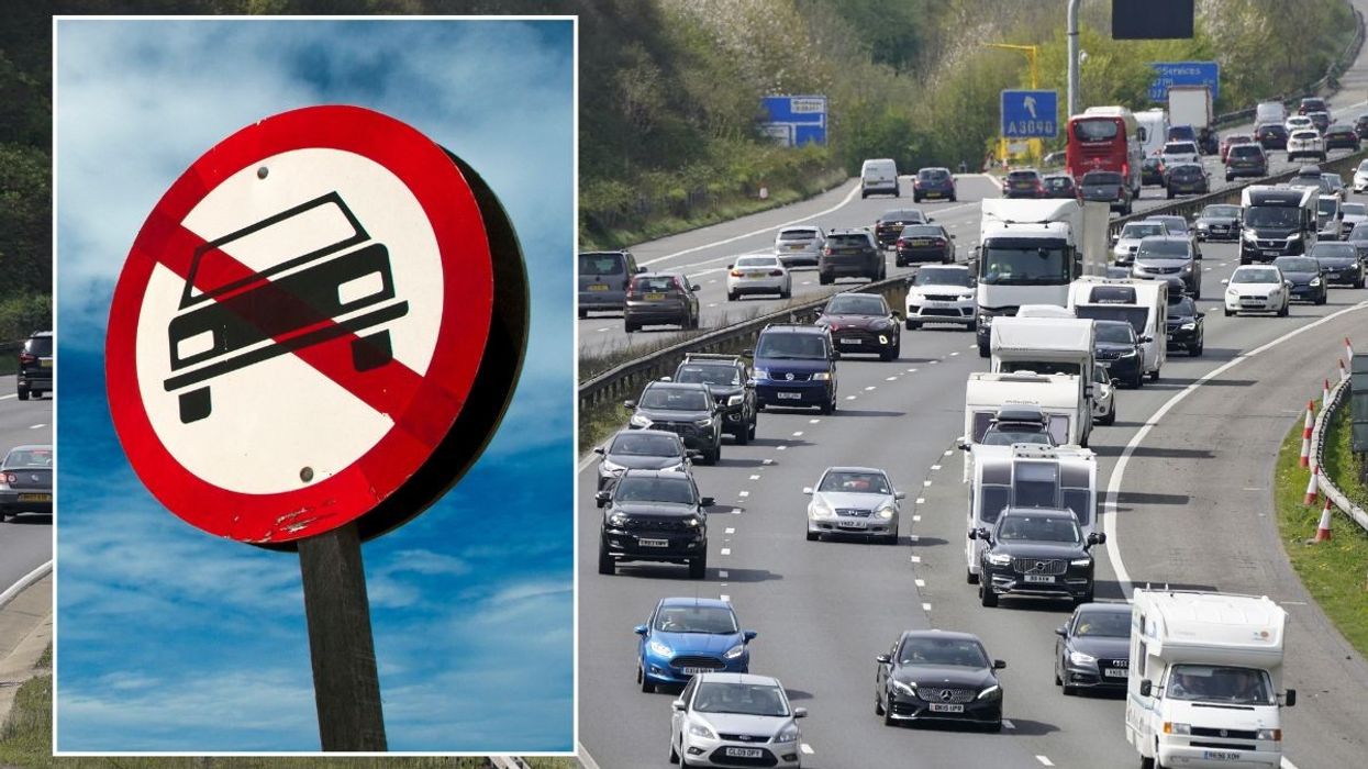 Car ban sign and a busy motorway