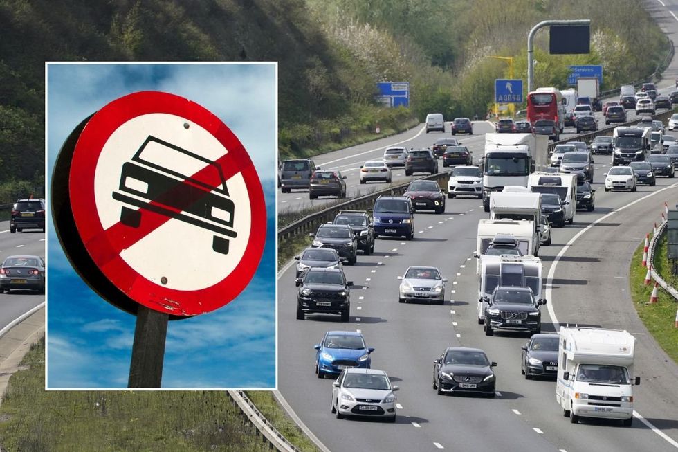 Car ban sign and a busy motorway