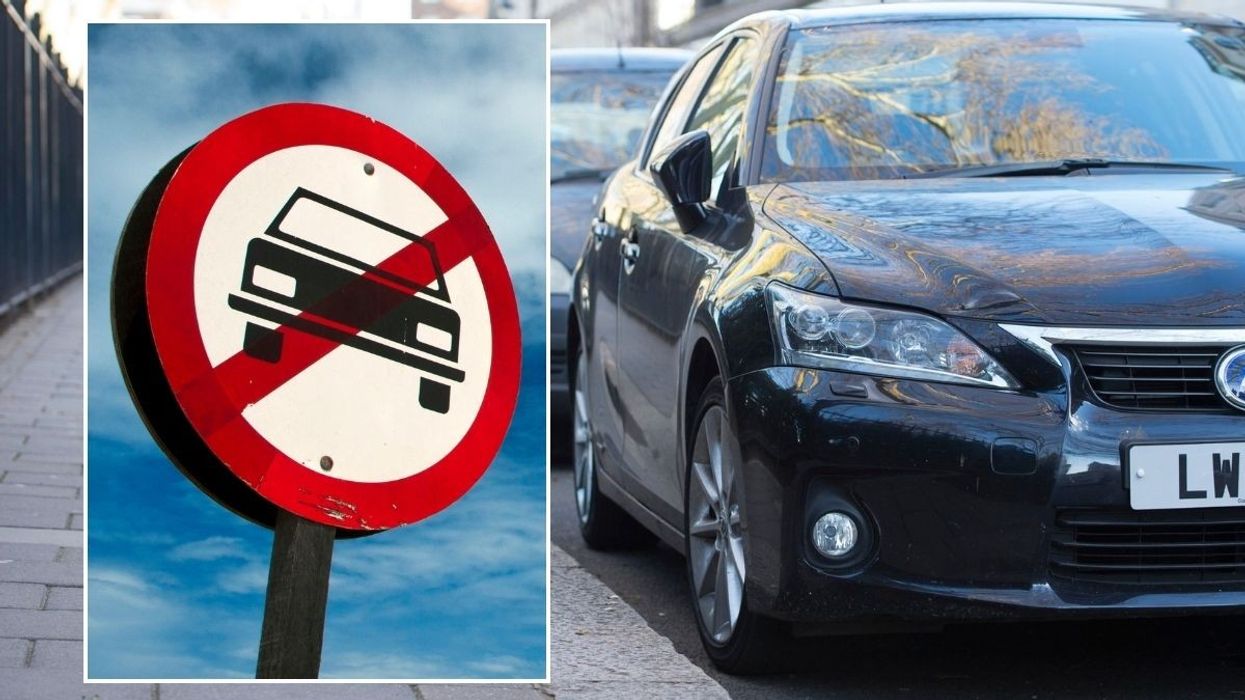 Car ban sign and cars parked
