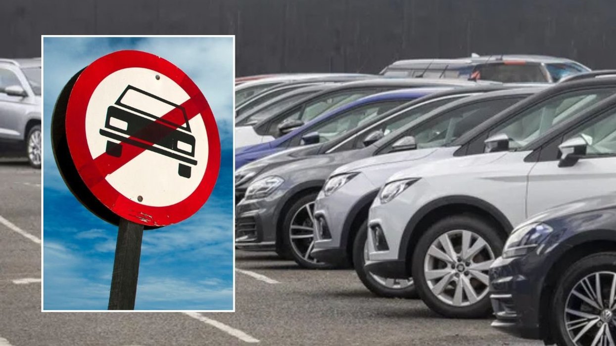 Car ban sign and vehicles parked