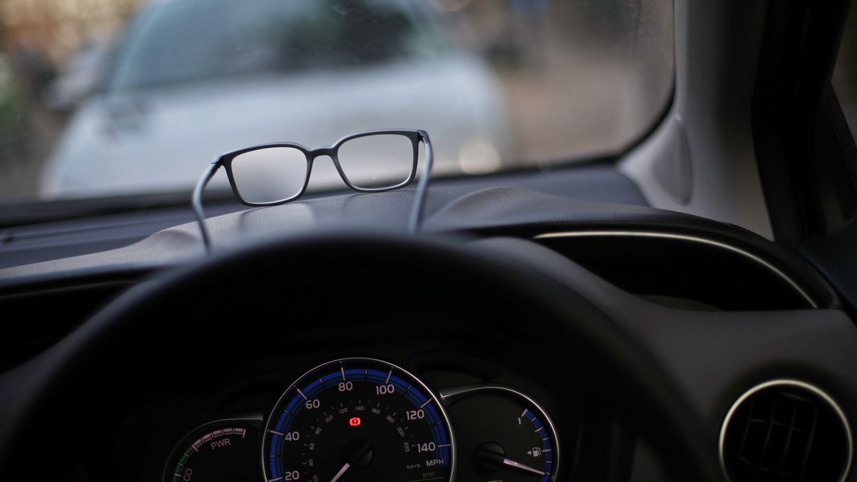 Car dashboard with a pair of glasses