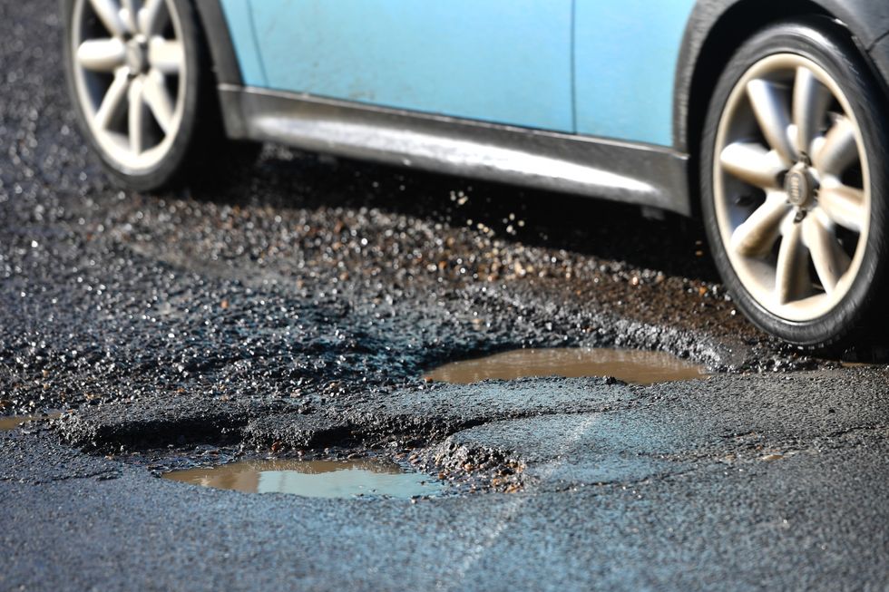 Car driving over a pothole