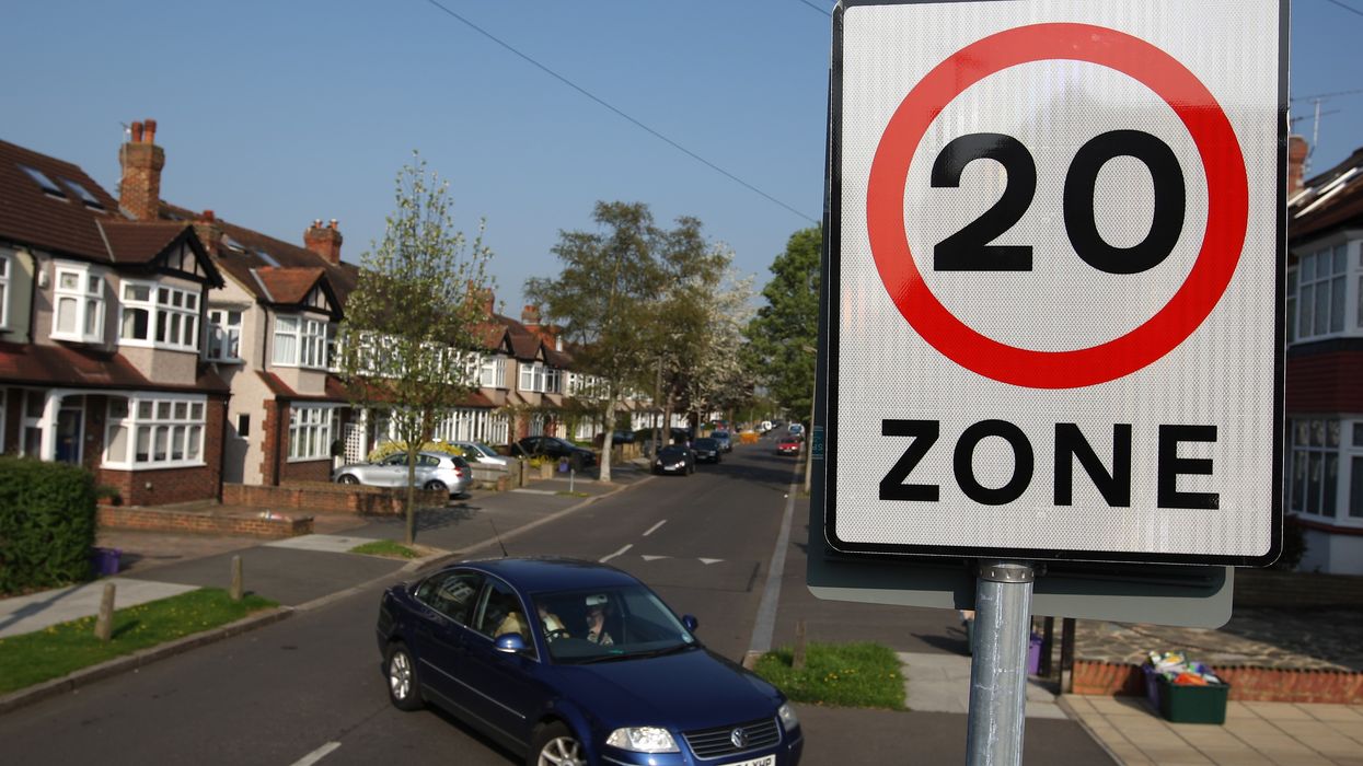 Car driving past 20mph speed limit sign