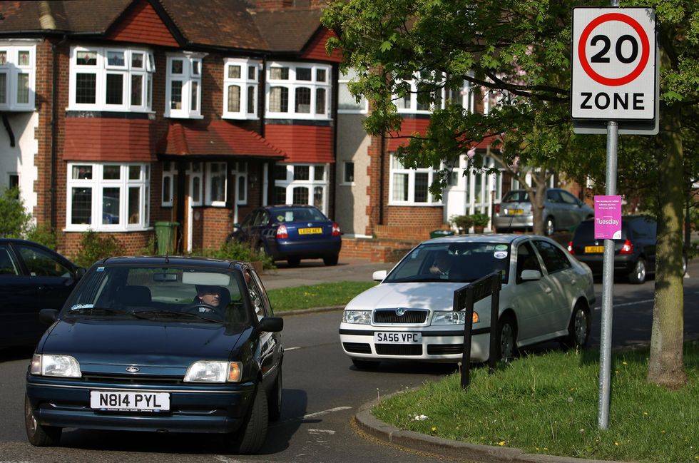 Car driving past 20mph speed limit sign