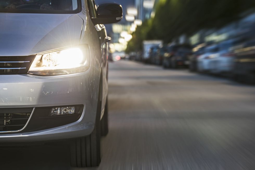 Car headlight on road