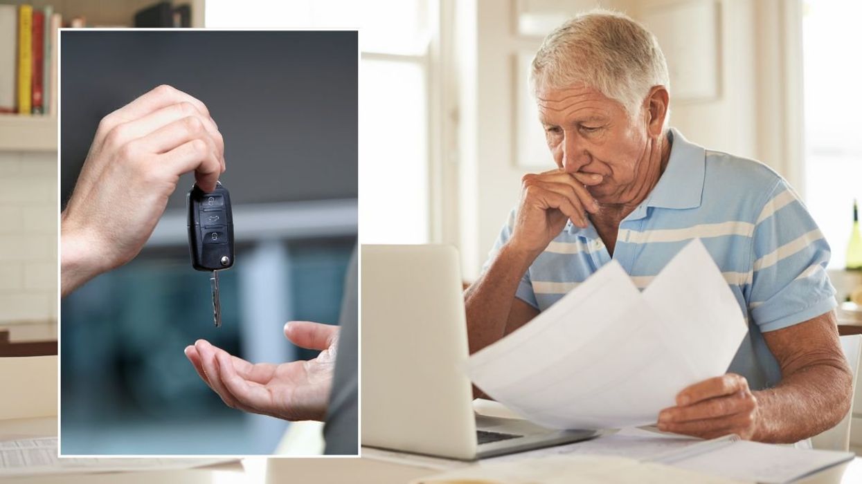 Car keys and a man checking a laptop