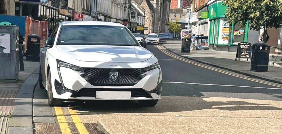 Car parked on yellow lines