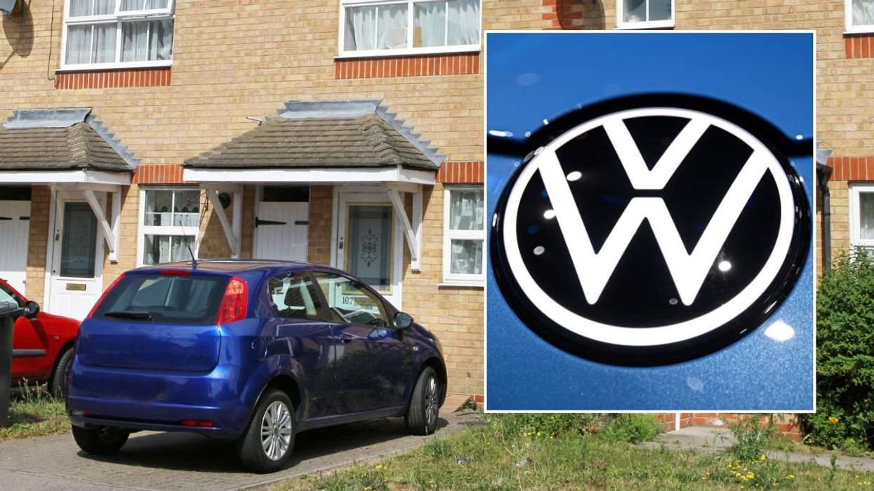 Car parked outside home and a VW logo