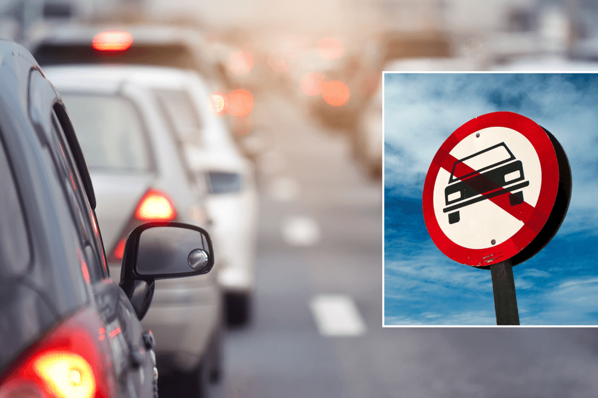 Car traffic and a car ban sign
