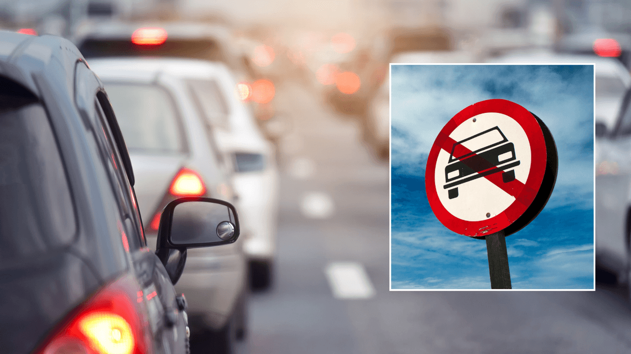 Car traffic and a car ban sign