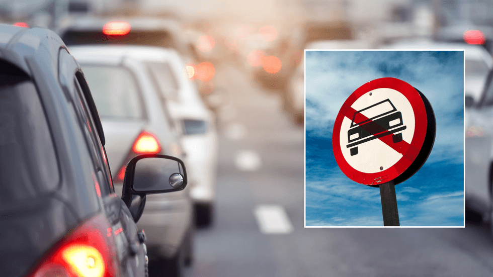 Car traffic and a car ban sign