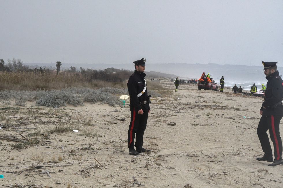 Carabinieri officers stand at the beach where bodies believed to be of refugees were found after a shipwreck, in Cutro, the eastern coast of Italy's Calabria region, Italy, February 26, 2023. REUTERS/Giuseppe Pipita NO RESALES. NO ARCHIVES.