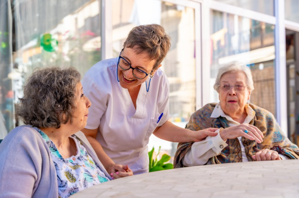 Care home nurse with two patients