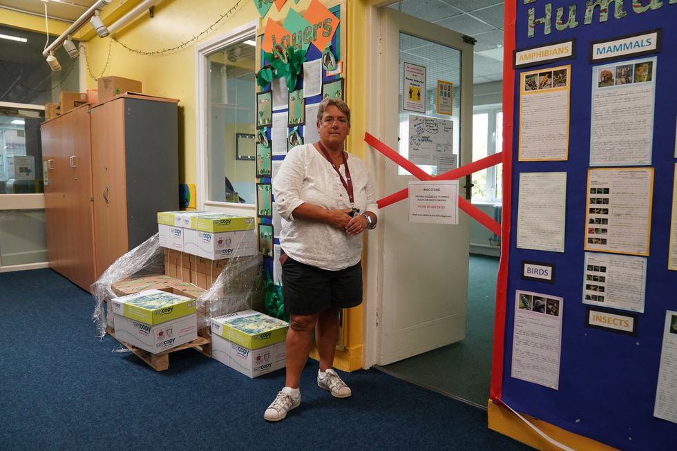 Caroline Evans, head teacher of Parks Primary School in Leicester stands next to a taped off section inside the school which has been affected with sub standard reinforced autoclaved aerated concrete (RAAC)
