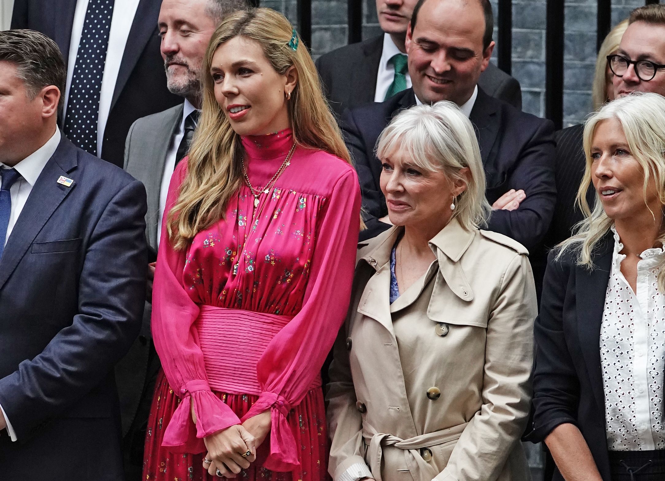 Carrie Johnson (left) and Nadine Dorries (right) watch Prime Minister Boris Johnson make a speech outside 10 Downing Street, London