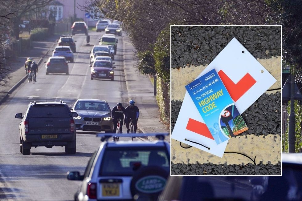 Cars and cyclists on a road with a copy of the Highway Code