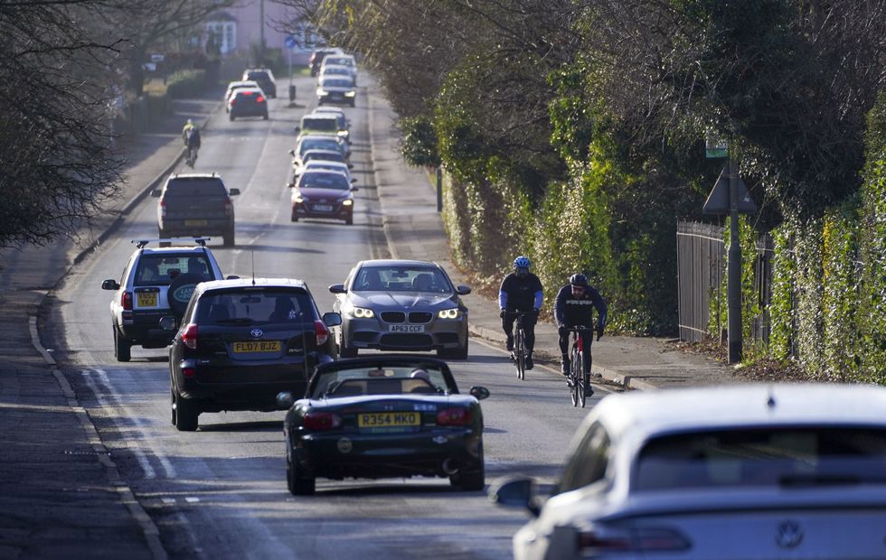 Cars and cyclists on a road.