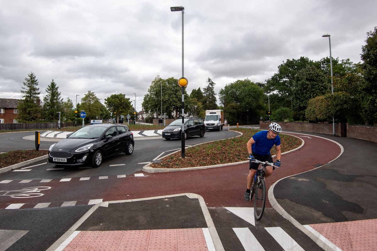 Cars and cyclists on a roundabout