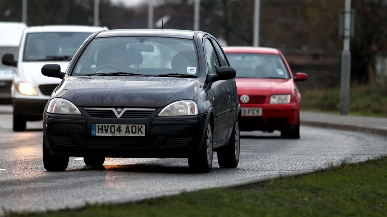 Cars drive round the perimeter road at Heathrow Airport