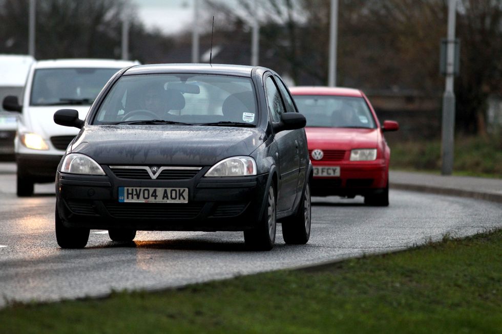 Cars drive round the perimeter road at Heathrow Airport