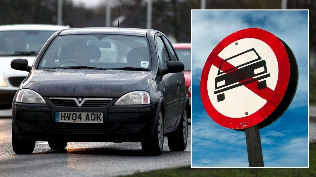 Cars driving and a vehicle ban sign