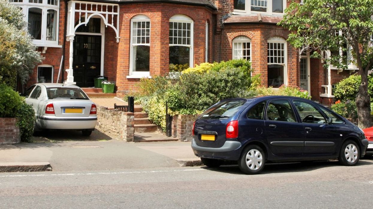 Cars parked in front of a house