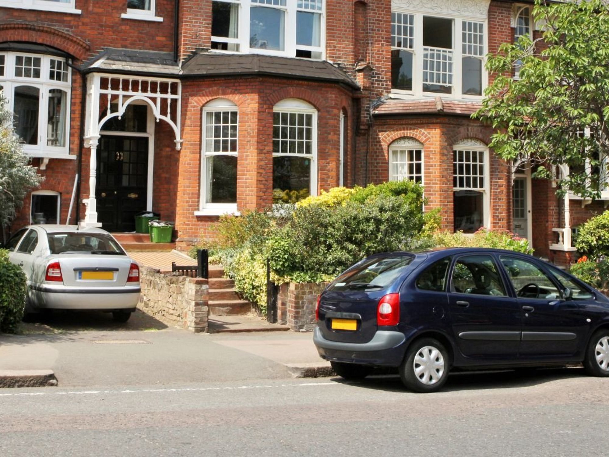 Cars parked in front of a house
