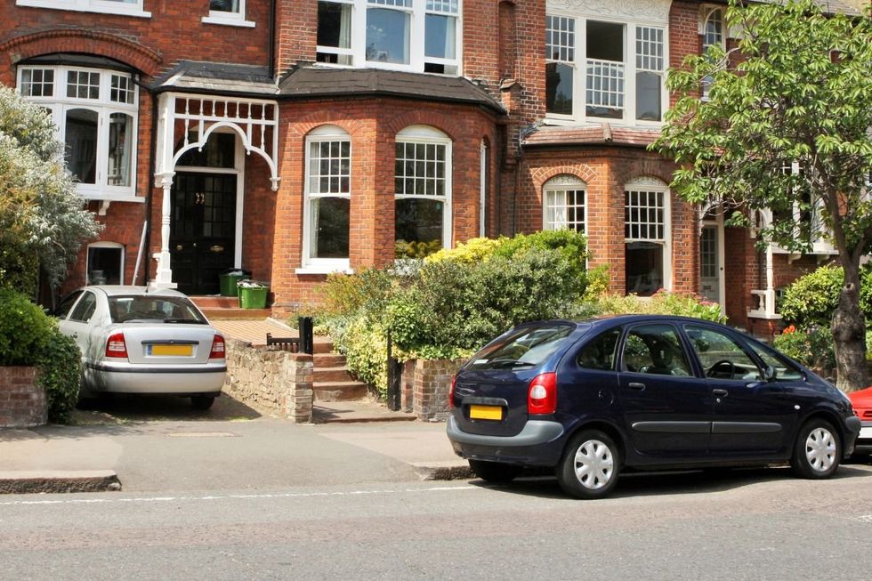 Cars parked in front of a house
