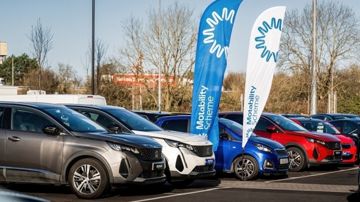 Cars parked in front of a Motability sign