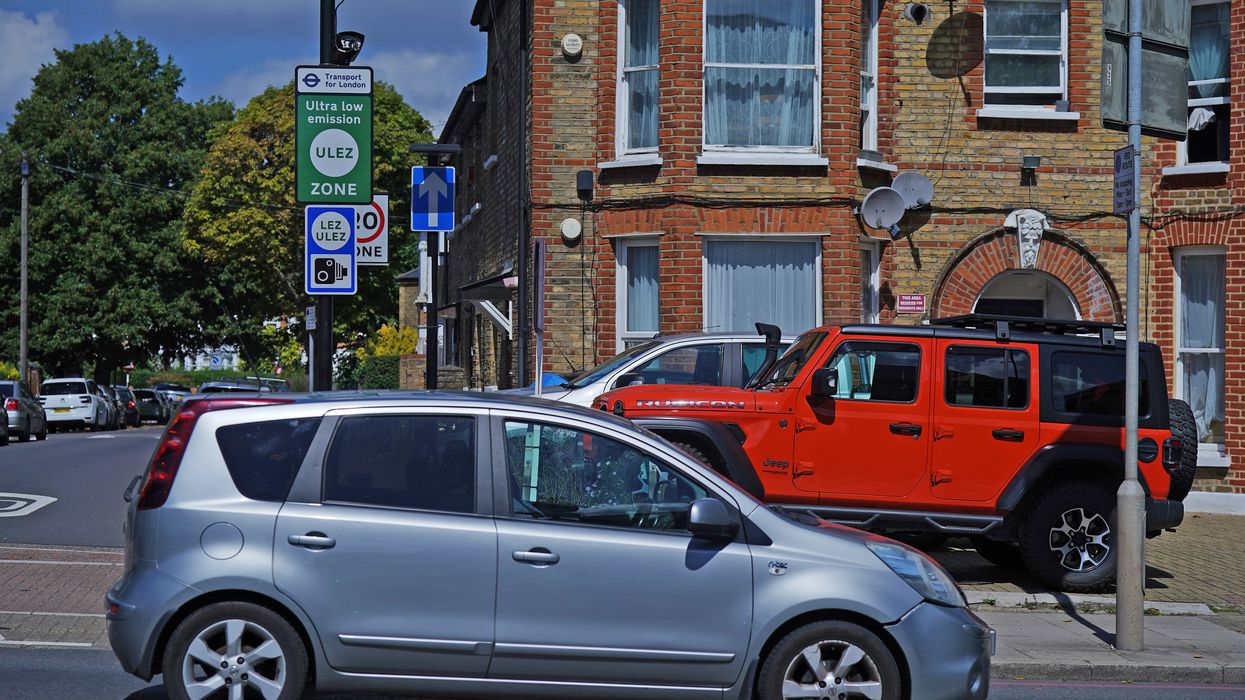Cars parked in front of a Ulez sign
