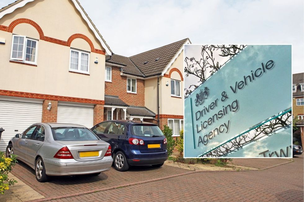 Cars parked on a driveway outside a house and a DVLA sign