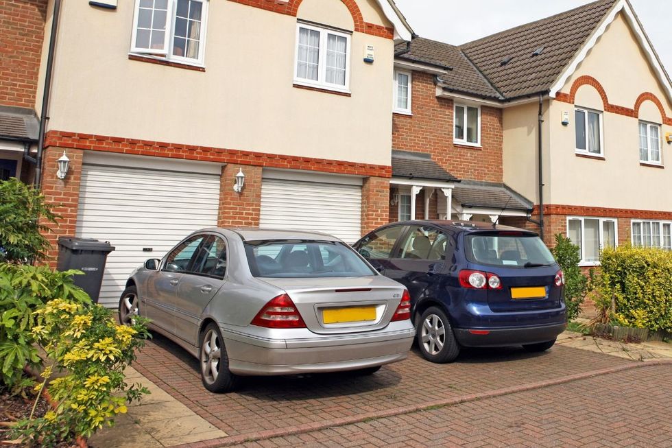 Cars parked on driveway in front of a house