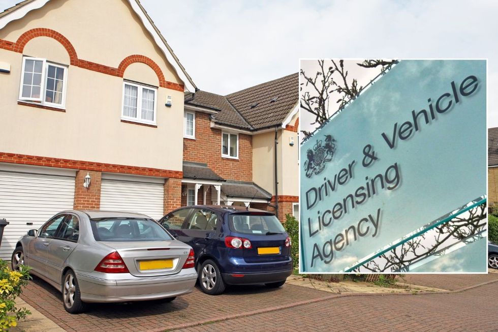 Cars parked on the driveway of a house and a DVLA sign