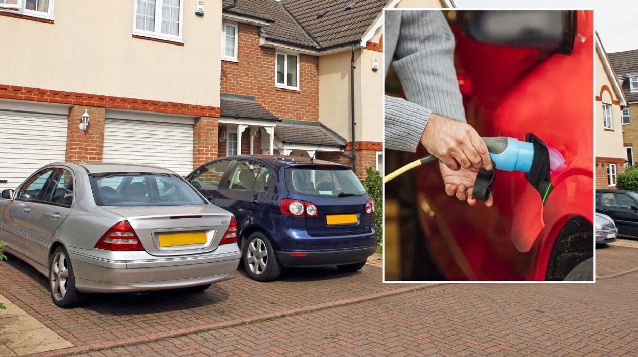 Cars parked outside a house and an electric car charger