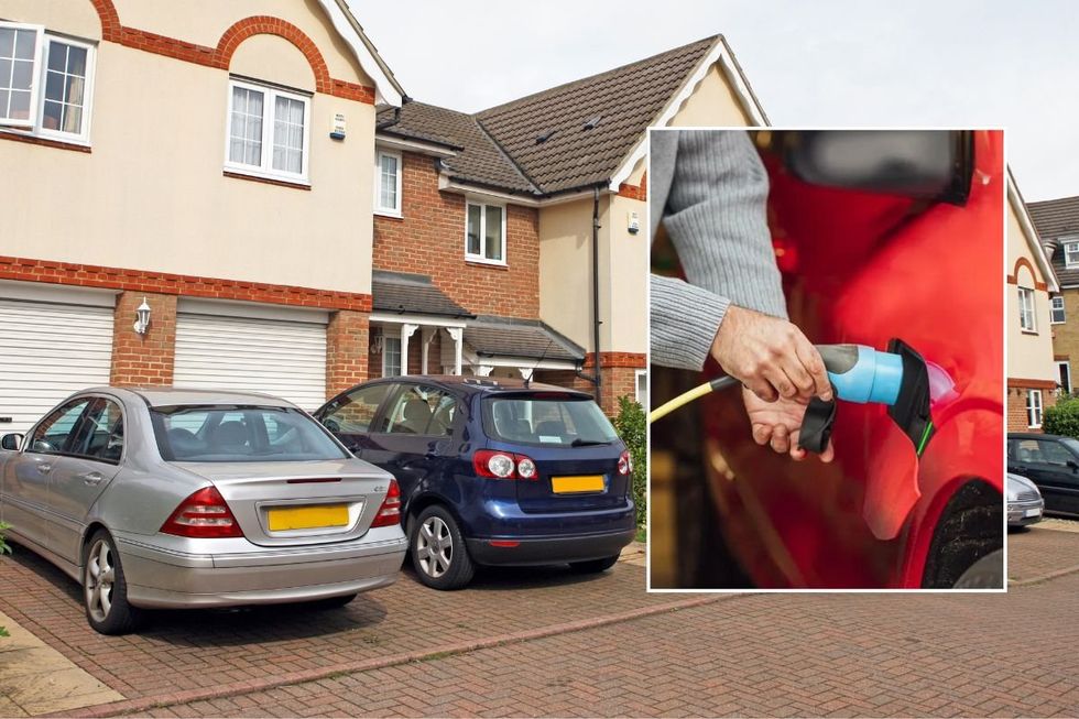 Cars parked outside a house and an electric car charger