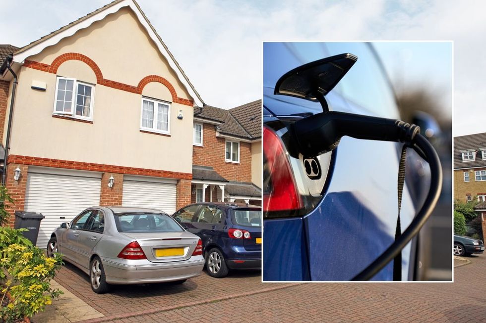 Cars parked outside of a house and an electric car charging