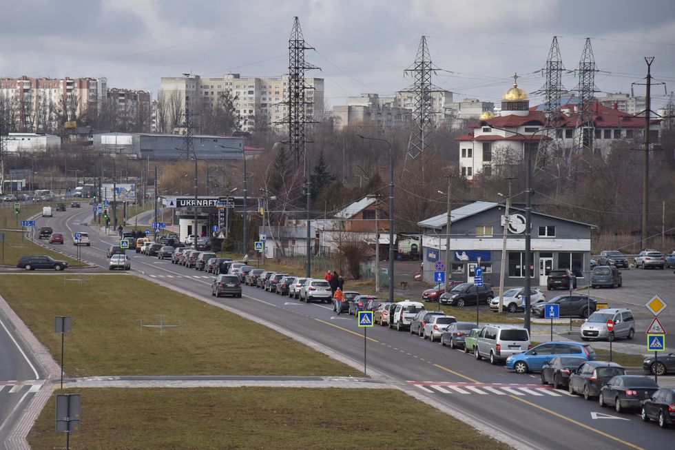 Cars queue at a gas station, after Russian President Vladimir Putin authorised a military operation in eastern Ukraine, in Lviv, Ukraine February 24, 2022. REUTERS/Pavlo Palamarchuk