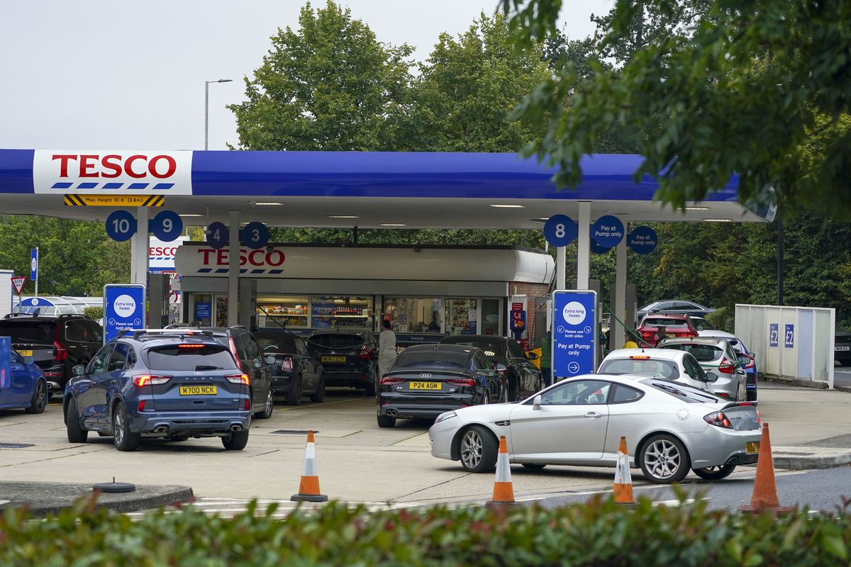 Cars queuing for fuel at a Tesco petrol station