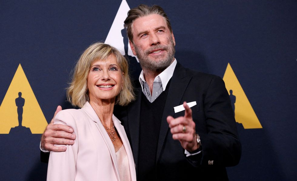 Cast members John Travolta and Olivia Newton-John pose at a 40th anniversary screening of %22Grease%22.