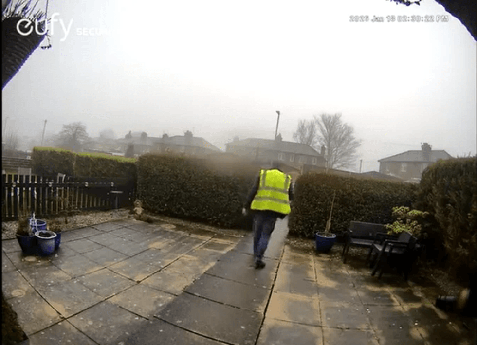 Catalin Stancu snatching a tabby cat from a family's front garden