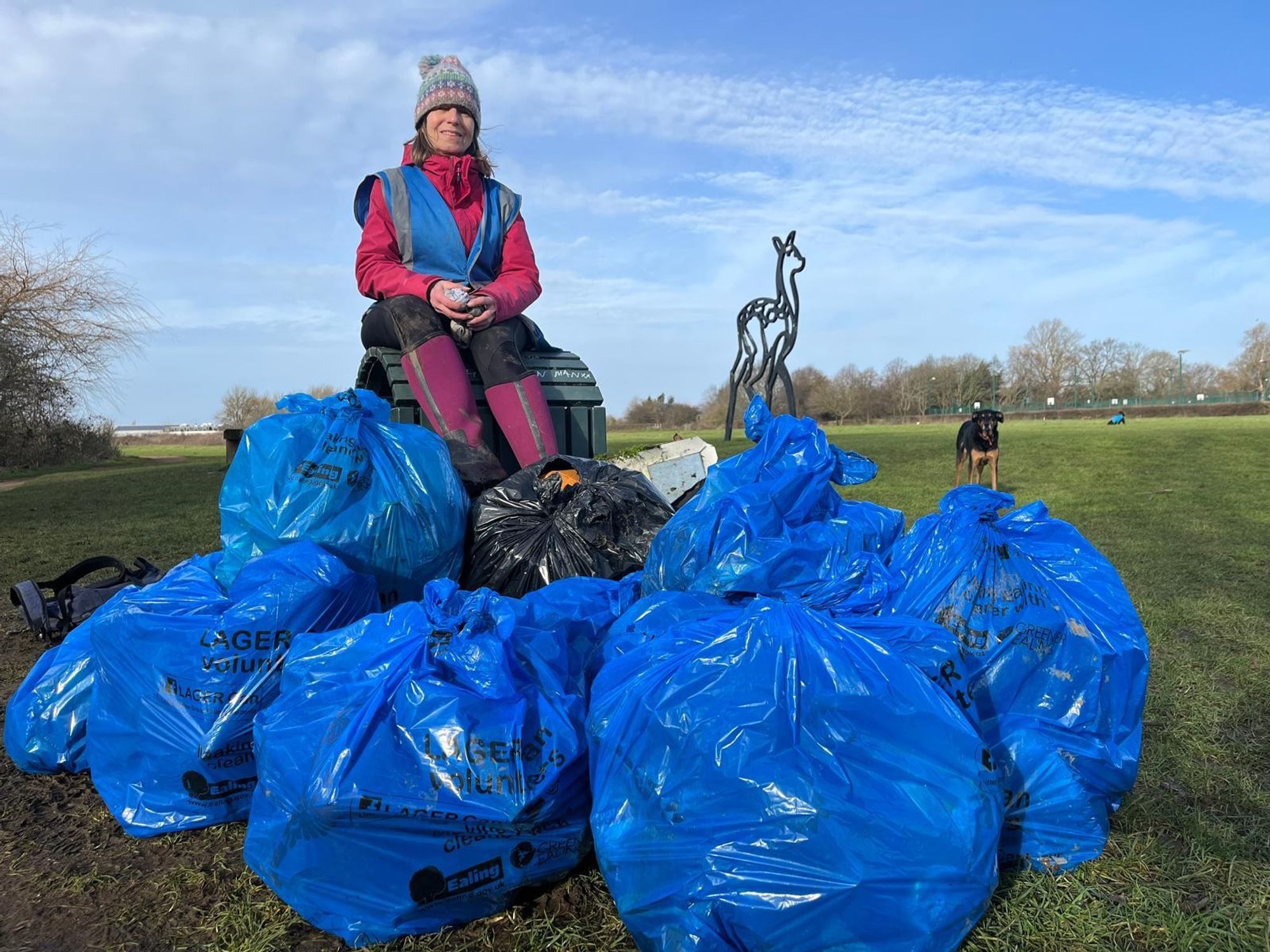 Cathy Swift sitting on a pile of rubbish