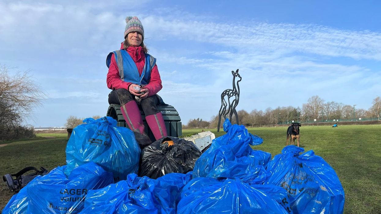 Cathy Swift sitting on a pile of rubbish